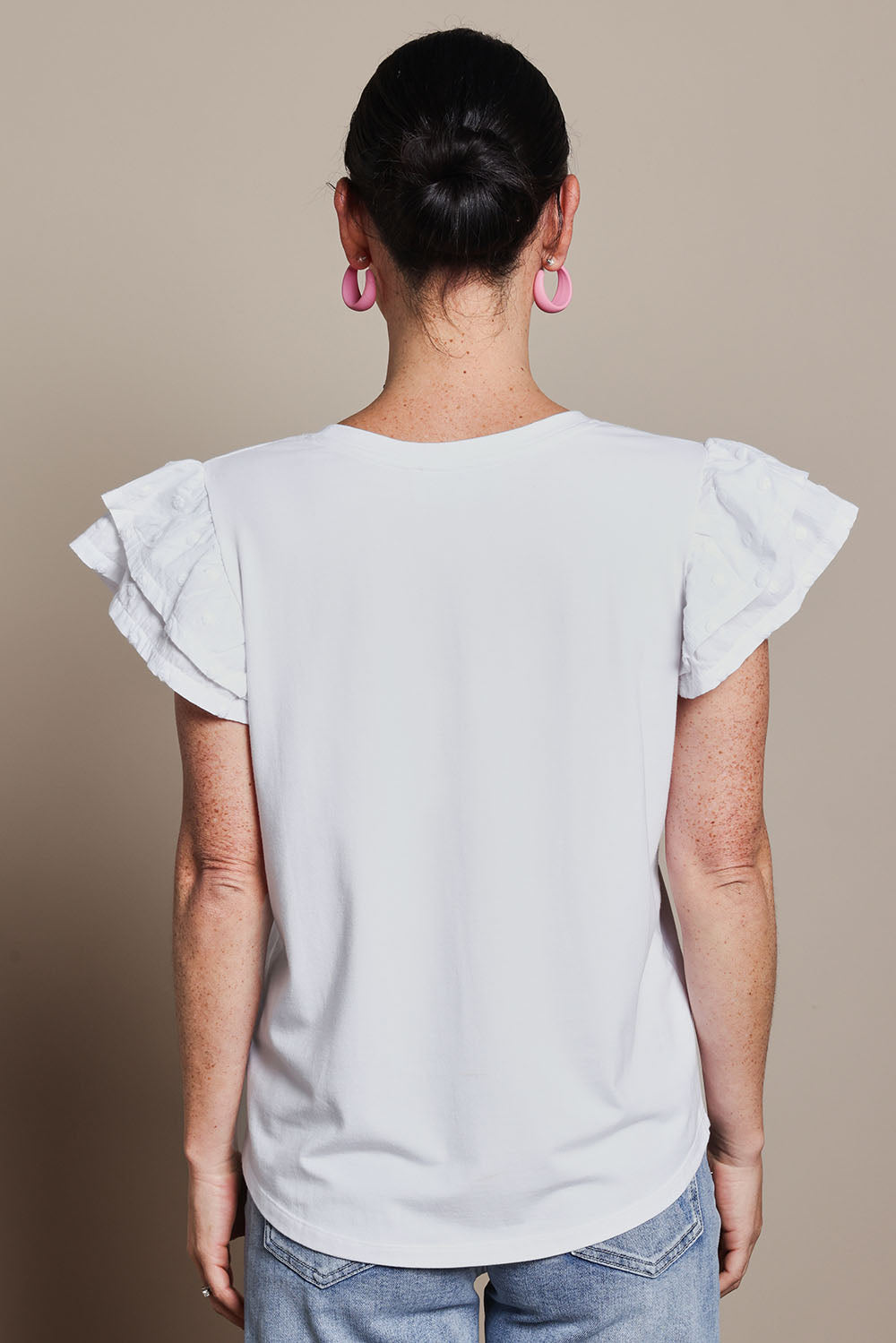 Model Katie wearing size 10 of the Ruffle Sleeve Top in colour White (White), from the back