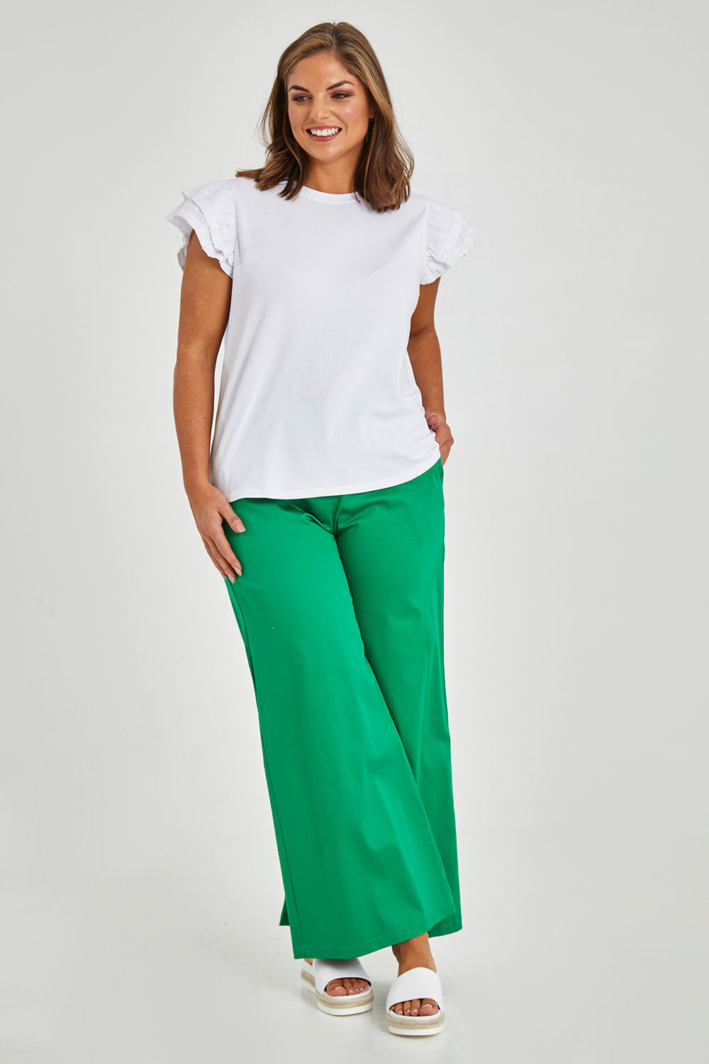 Model Monique wearing size 14 of the Ruffle Sleeve Top in colour White (White), from the front, showing the whole outfit