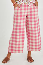 Model Monique wearing size 14 of the Wide Leg Cropped Pant in colour Pinkcheck (Pink), from the front, cropped image