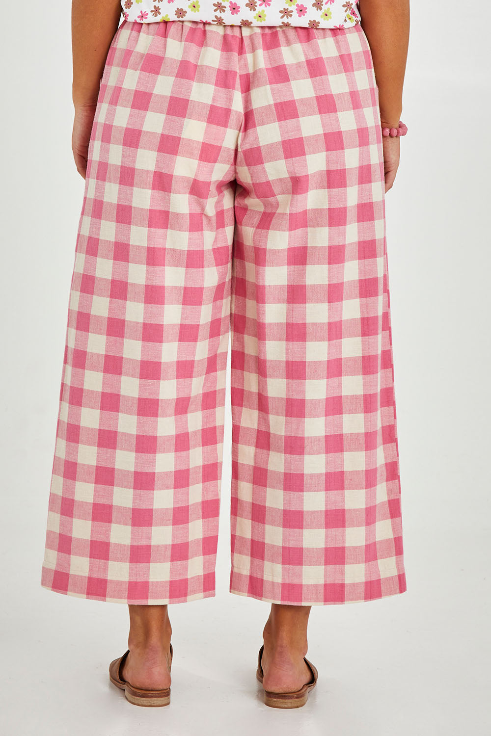 Model Monique wearing size 14 of the Wide Leg Cropped Pant in colour Pinkcheck (Pink), from the front, cropped image