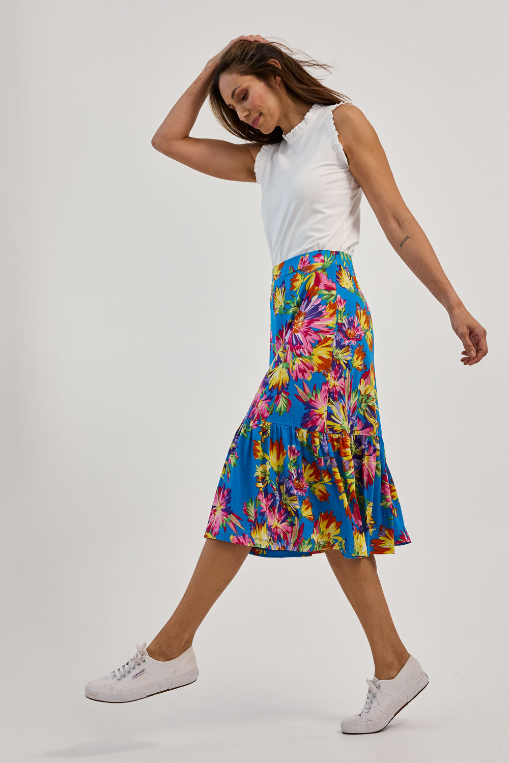 Model Amanda wearing size 10 of the Ruffle Skirt in colour Garden (Blue), from the front, showing the whole outfit