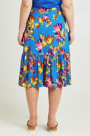 Model Jane wearing size 14 of the Ruffle Skirt in colour Garden (Blue), from the back