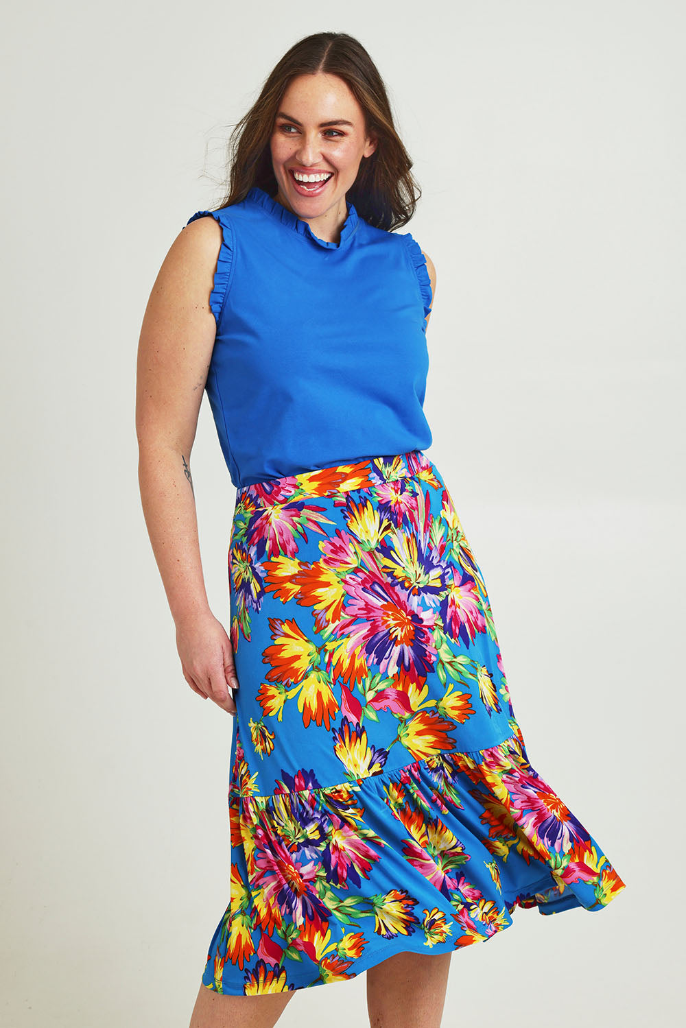 Model Jane wearing size 14 of the Ruffle Skirt in colour Garden (Blue), from the front, cropped image