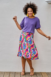 Model Olivia wearing size 10 of the Elastic Waist Skirt in colour Graphic (Purple), from the front, showing the whole outfit