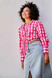 Model Olivia wearing size 10 of the Printed Tie Neck Blouse in colour Berrycheck (Pink), from the front, showing the whole outfit