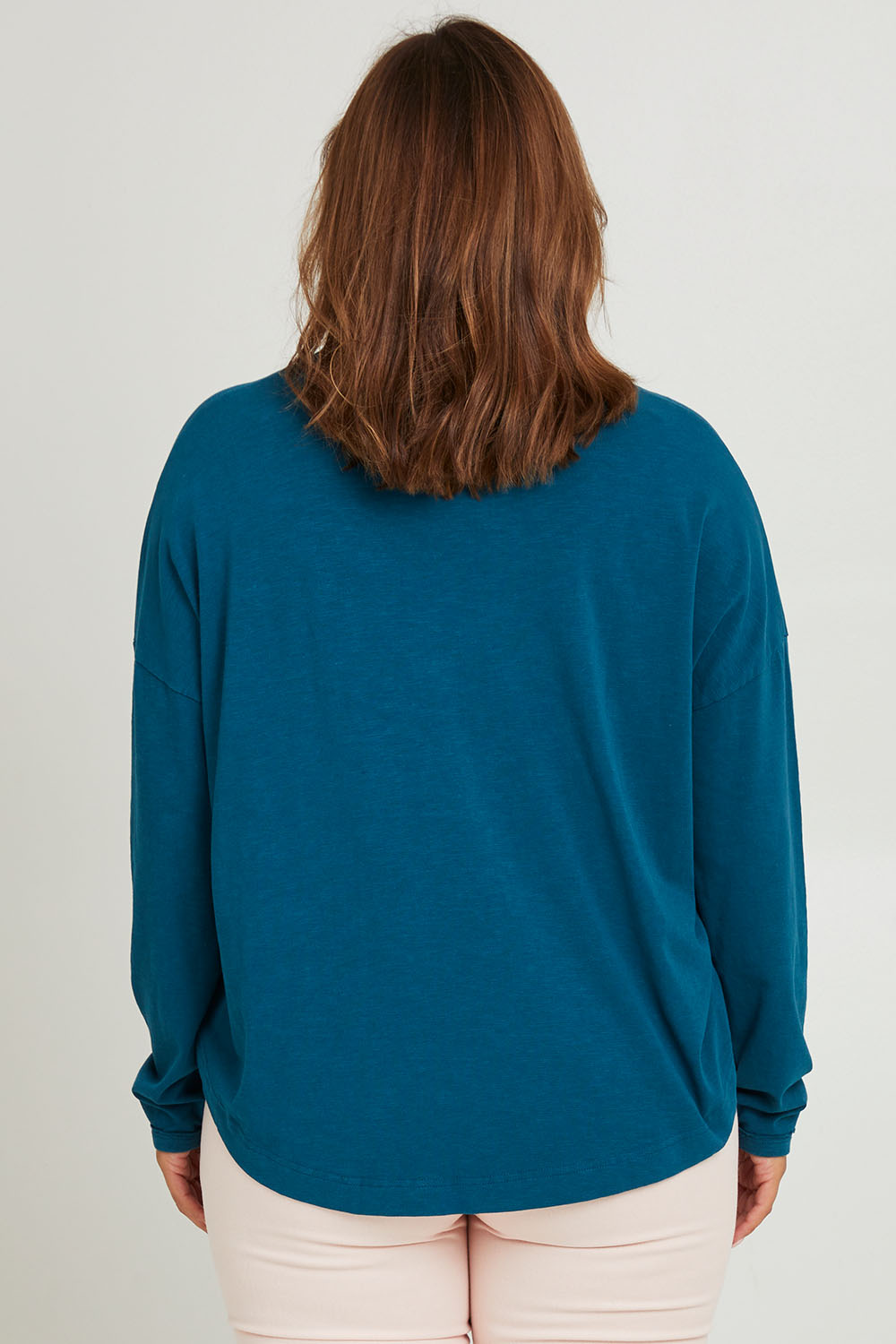 Model Monique wearing size 14 of the Love Long Sleeve Tee in colour Love (Blue), from the back