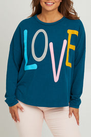Model Monique wearing size 14 of the Love Long Sleeve Tee in colour Love (Blue), from the front, cropped image