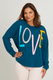 Model Monique wearing size 14 of the Love Long Sleeve Tee in colour Love (Blue), from the front, cropped image