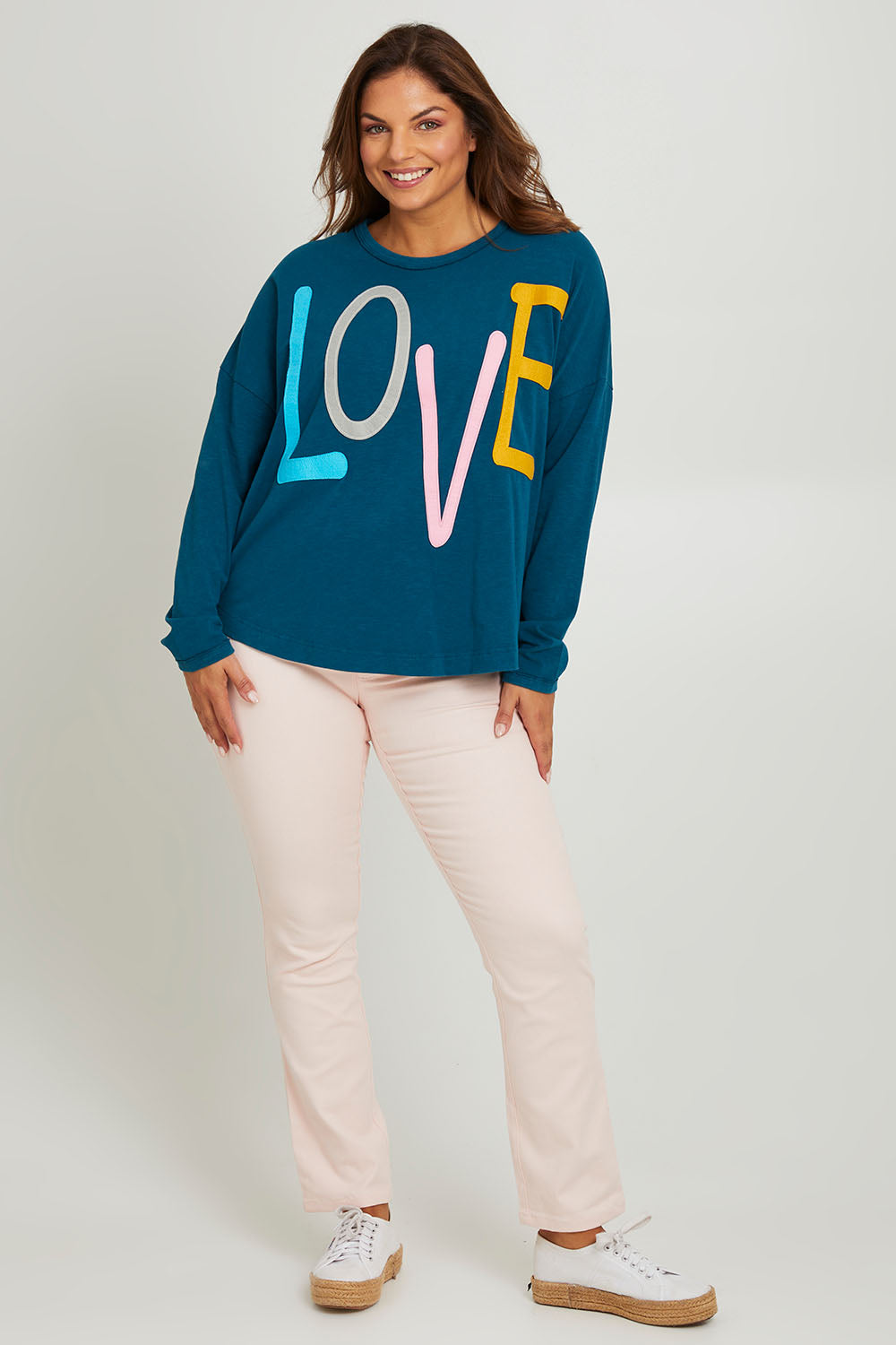 Model Monique wearing size 14 of the Love Long Sleeve Tee in colour Love (Blue), from the front, showing the whole outfit