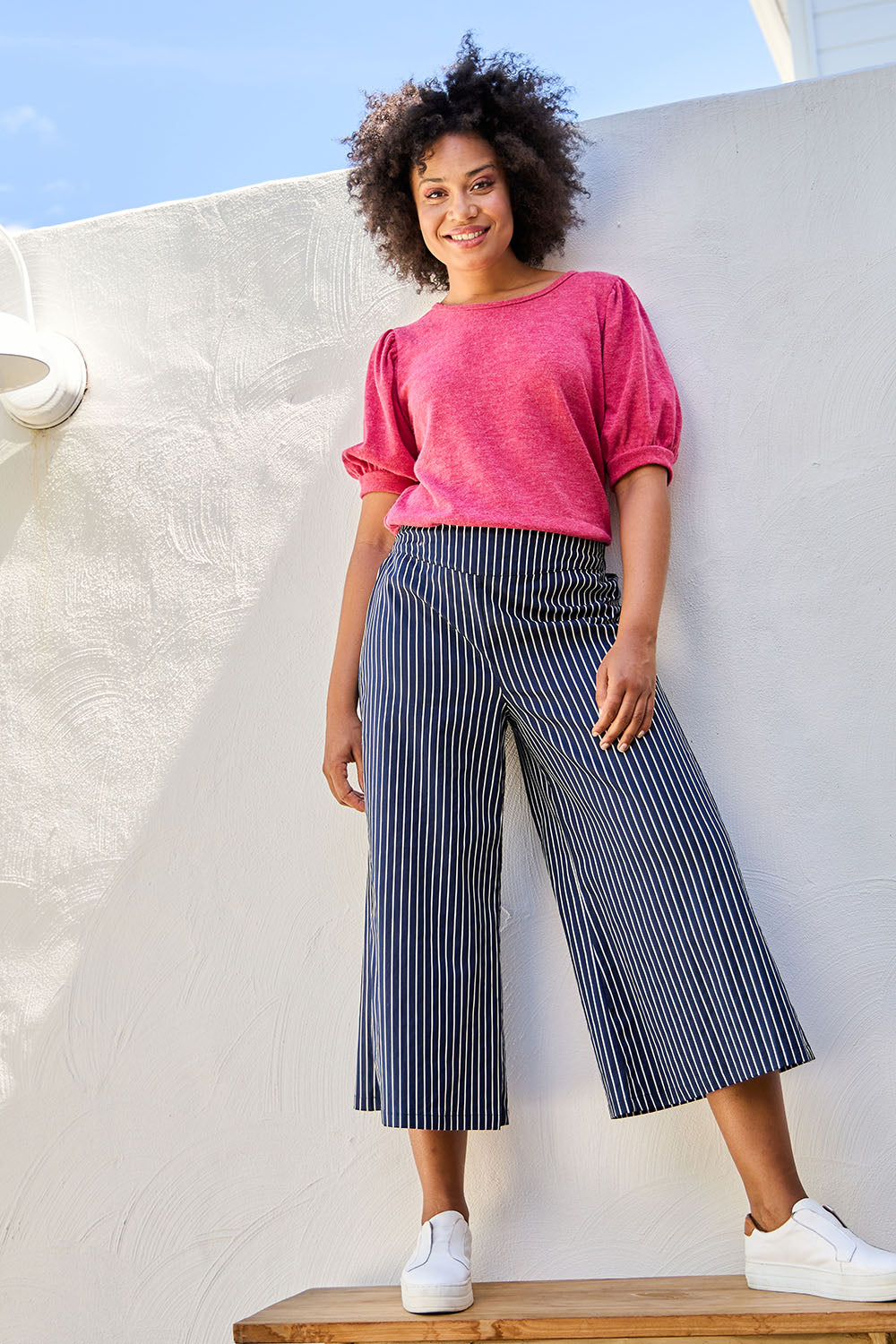 Model Olivia wearing size 10 of the Striped Wide Leg Pant in colour Navywhite (Blue), from the front, showing the whole outfit