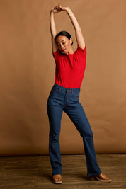 Model Katie wearing size 10 of the Bell Bottom Jeans in colour Middenim (Blue), from the front, showing the whole outfit