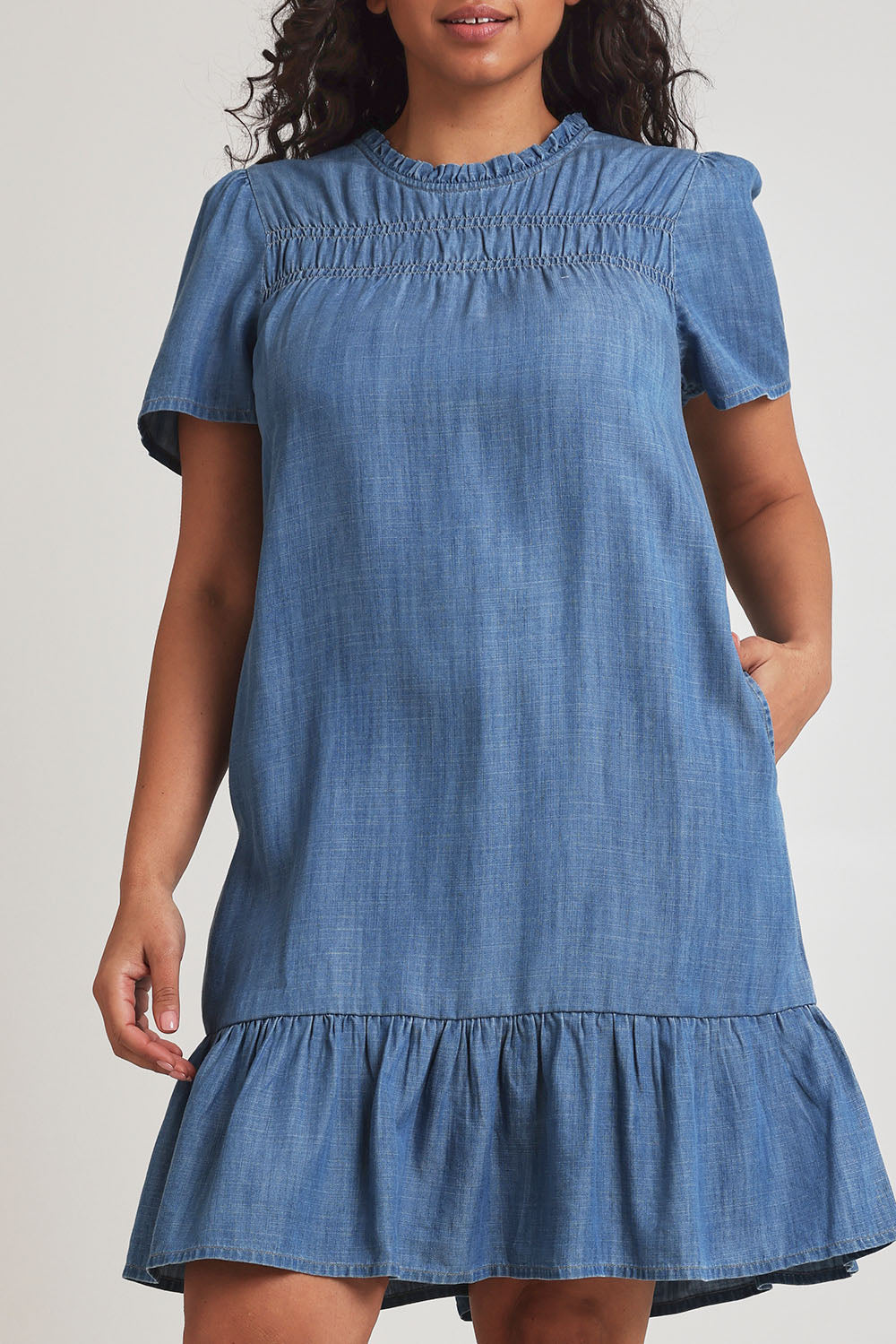 Model Terri-Leigh wearing size 14 of the Frill Hem Dress in colour Blue (Blue), from the front, cropped image