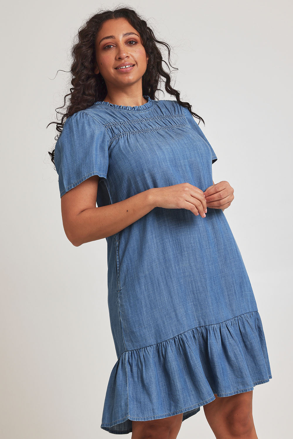 Model Terri-Leigh wearing size 14 of the Frill Hem Dress in colour Blue (Blue), from the front, cropped image