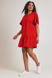 Model Terri-Leigh wearing size 14 of the Flutter Sleeve Frill Hem Dress in colour Tomato (Red), from the front, showing the whole outfit