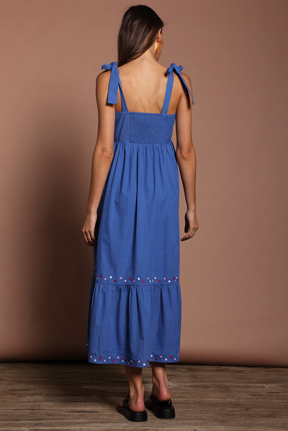 Model Madeline wearing size 10 of the Cotton Embroidered Midi Dress in colour Blue (Blue), from the back
