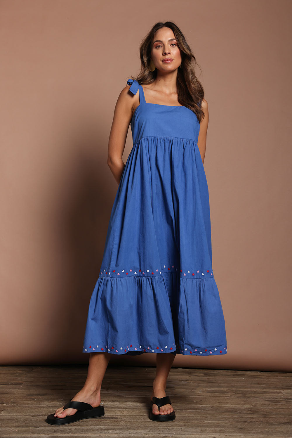 Model Madeline wearing size 10 of the Cotton Embroidered Midi Dress in colour Blue (Blue), from the front, showing the whole outfit