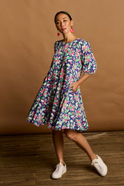 Model Katie wearing size 10 of the Flared Hem Dress in colour Floral, from the front, showing the whole outfit