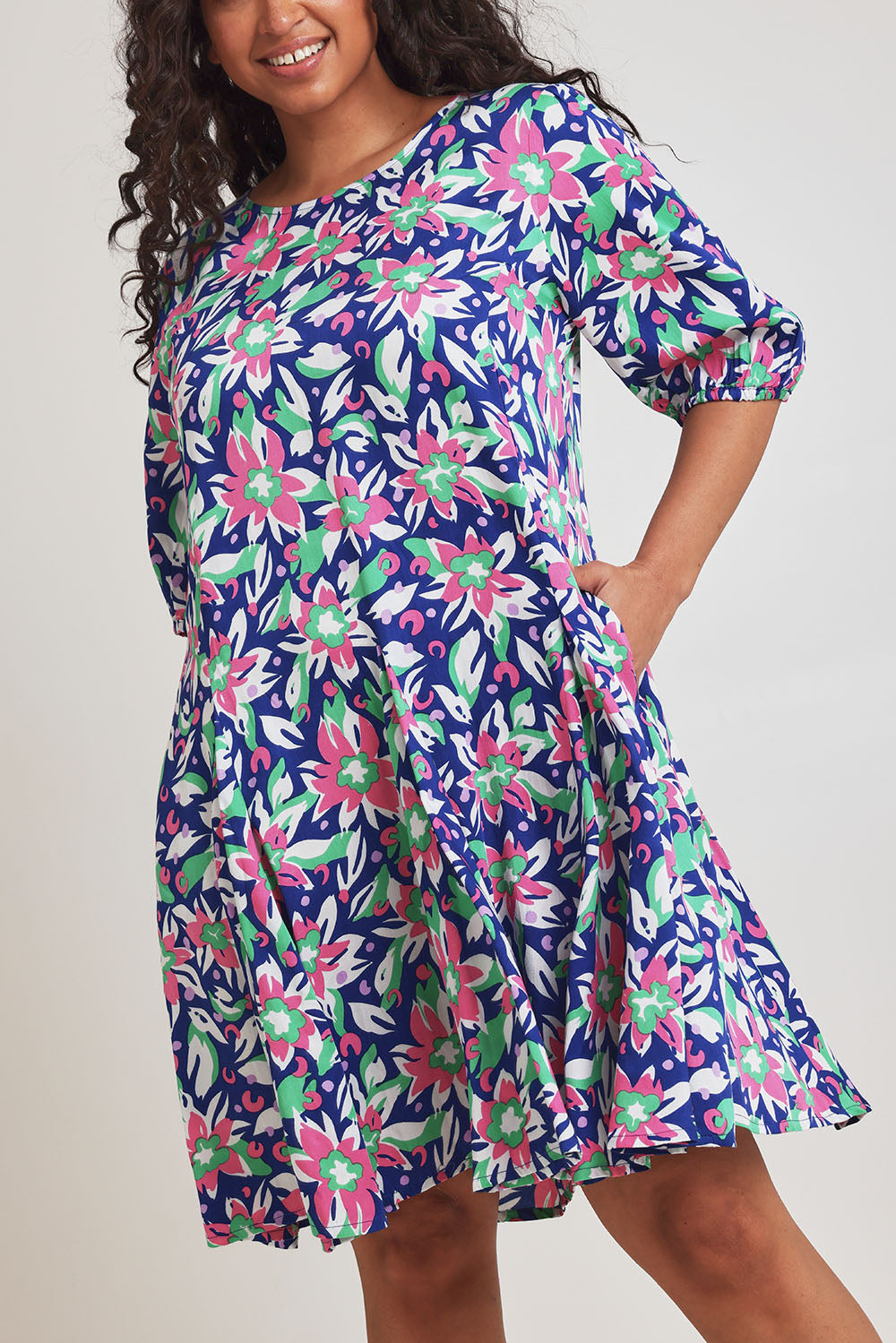 Model Terri-Leigh wearing size 14 of the Flared Hem Dress in colour Floral, from the front, cropped image