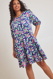 Model Terri-Leigh wearing size 14 of the Flared Hem Dress in colour Floral, from the front, cropped image