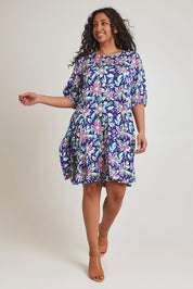 Model Terri-Leigh wearing size 14 of the Flared Hem Dress in colour Floral, from the front, showing the whole outfit