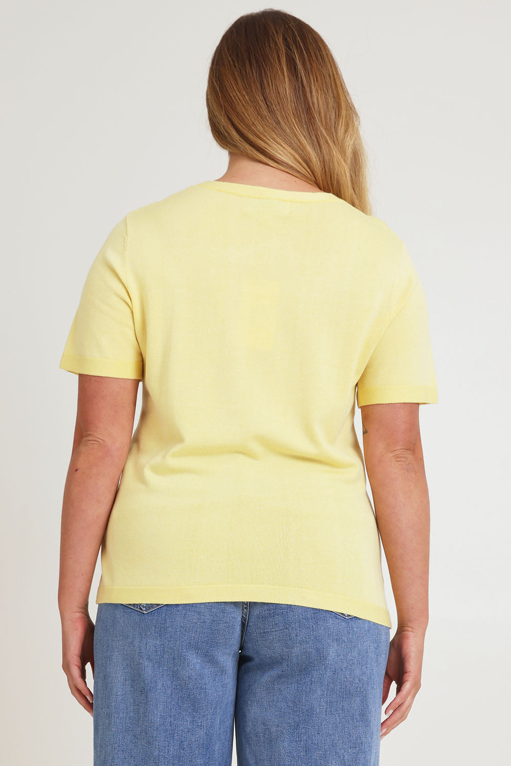 Model Chanel wearing size XL of the Short Sleeve Knit Top in colour Yellow, from the back