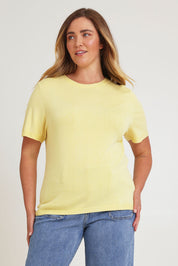 Model Chanel wearing size XL of the Short Sleeve Knit Top in colour Yellow, from the front, cropped image