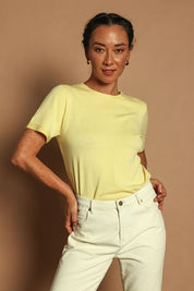Model Katie wearing size S of the Short Sleeve Knit Top in colour Yellow, from the front, showing the whole outfit