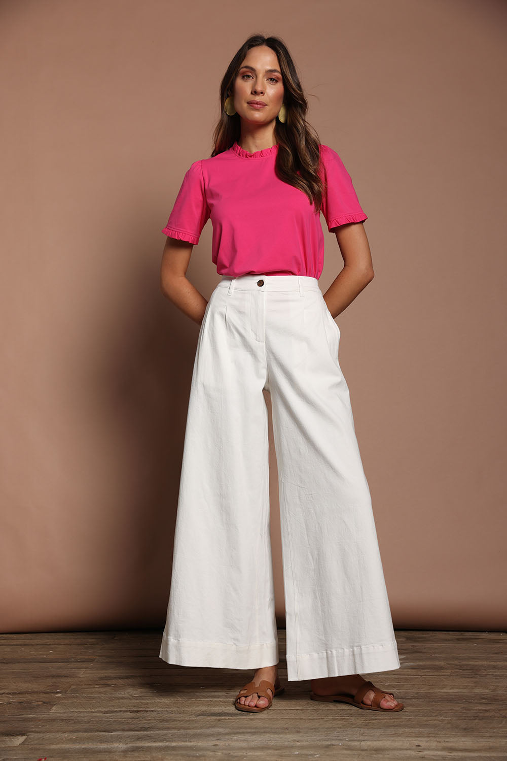 Model Madeline wearing size 10 of the Mercerised Cotton Frill Top in colour Pinkrose (Pink), from the front, showing the whole outfit