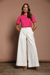 Model Madeline wearing size 10 of the Mercerised Cotton Frill Top in colour Pinkrose (Pink), from the front, showing the whole outfit