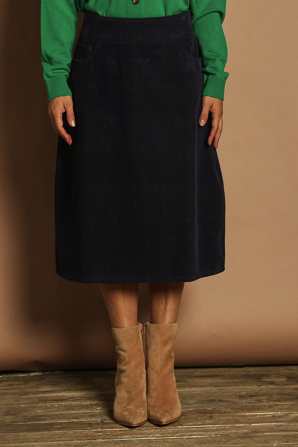 Model Katie wearing size 10 of the Cotton Corduroy A Line Skirt in colour Deepblue (Blue), from the front, cropped image