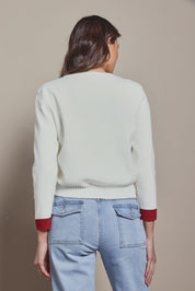 Model Madeline wearing size S of the Cotton Blend Heart Button Cardigan in colour Whiteheart (White), from the back