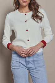 Model Madeline wearing size S of the Cotton Blend Heart Button Cardigan in colour Whiteheart (White), from the front, cropped image