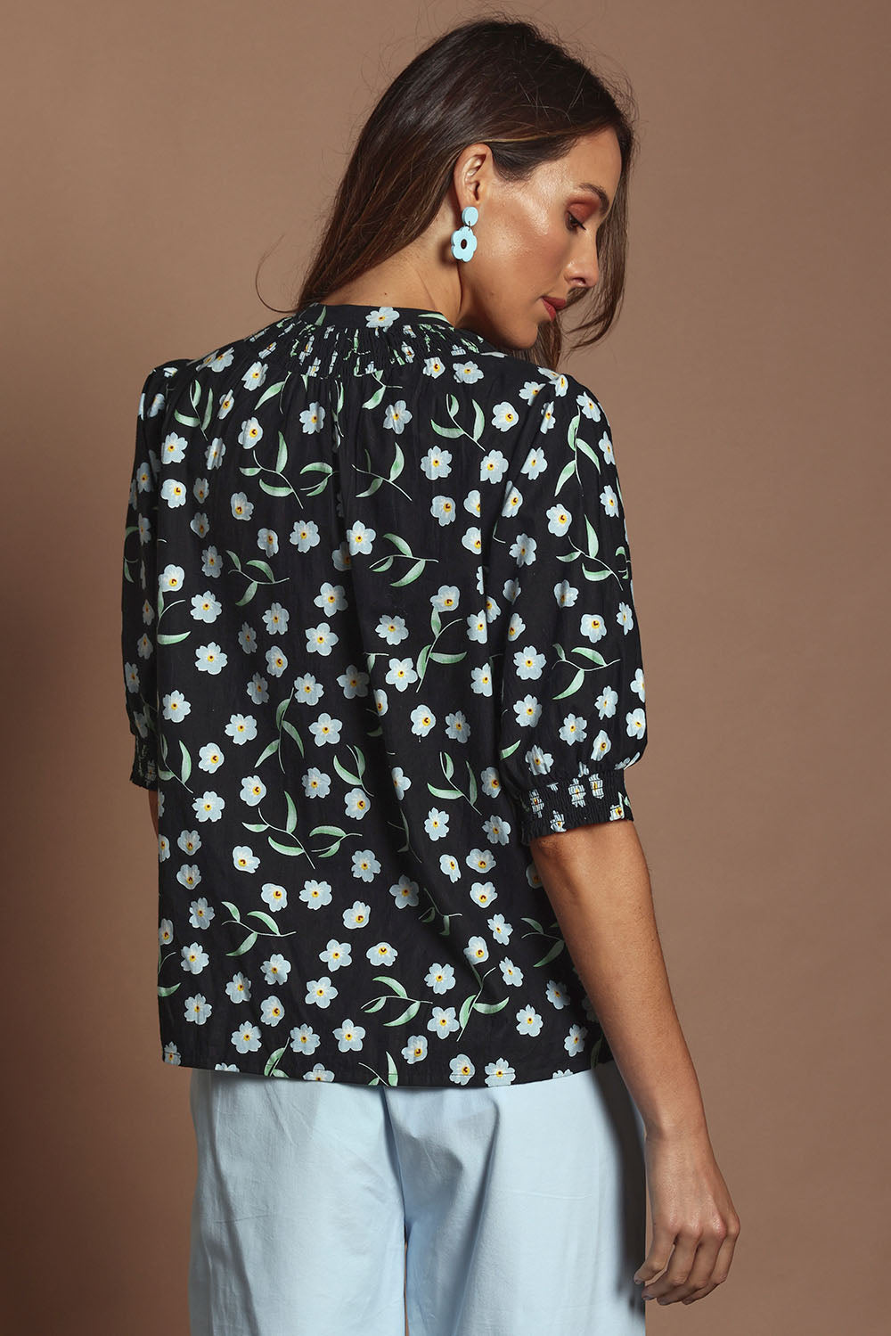 Model Madeline wearing size 10 of the Cotton Button Up Shirt in colour Floret (Black), from the back