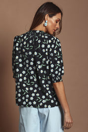 Model Madeline wearing size 10 of the Cotton Button Up Shirt in colour Floret (Black), from the back