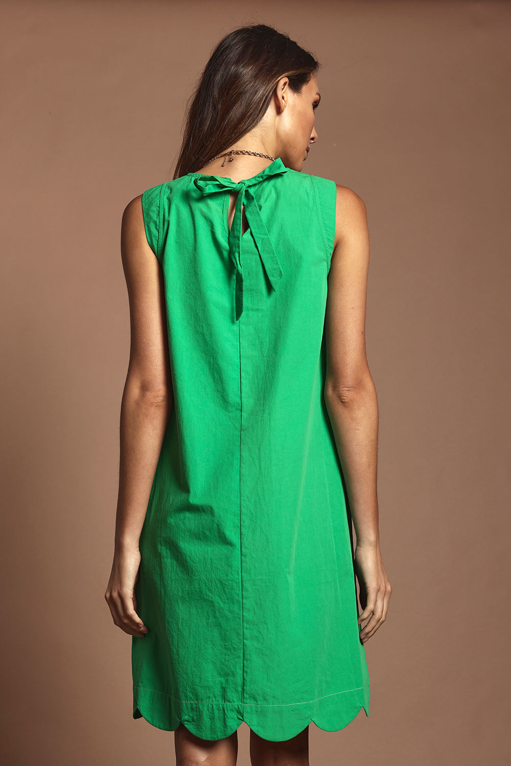 Model Madeline wearing size 10 of the Cotton Shift Dress in colour Green (Green), from the back
