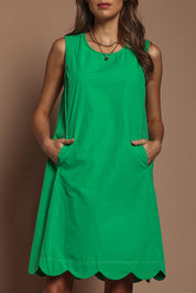 Model Madeline wearing size 10 of the Cotton Shift Dress in colour Green (Green), from the front, cropped image