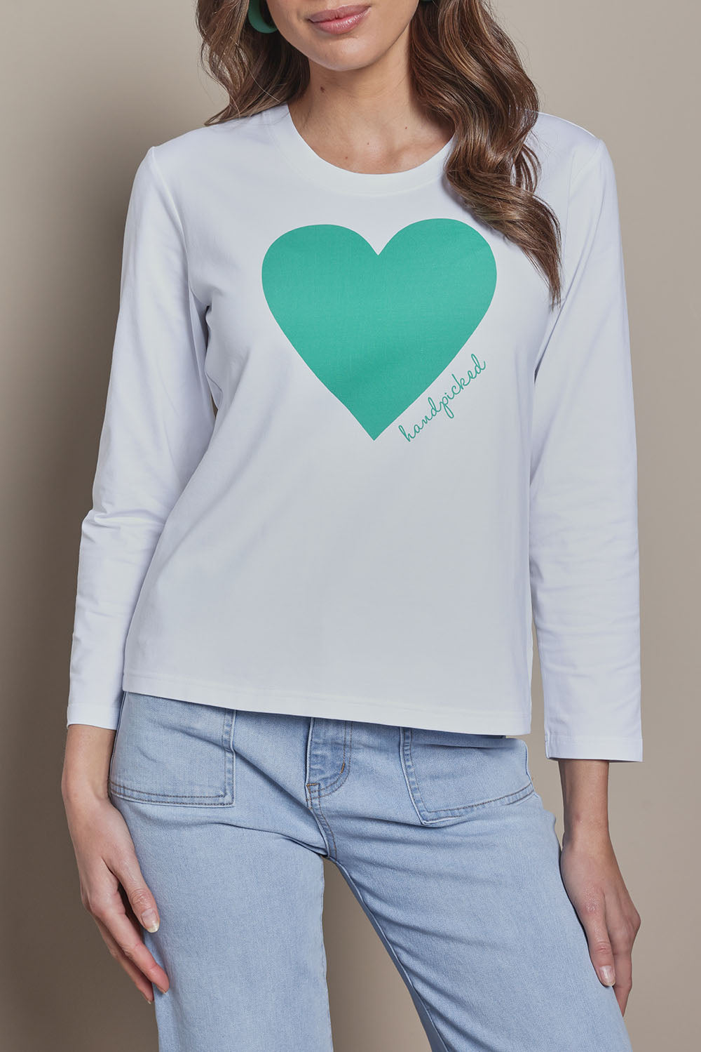 Model Madeline wearing size 10 of the Mercerized Cotton Love Long Sleeve Tee in colour Green (Green), from the front, cropped image