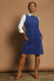 Model Katie wearing size 10 of the Corduroy Shift Dress in colour Bonnie (Blue), from the front, showing the whole outfit
