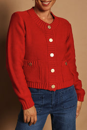 Model Katie wearing size S of the Cotton Cardigan in colour Red (Red), from the front, cropped image