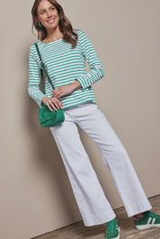 Model Madeline wearing size 10 of the Cotton Stripe Long Sleeve Top in colour Whitegreen (Green), from the front, showing the whole outfit
