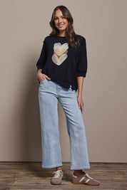Model Madeline wearing size 10 of the Heart 3/4 Sleeve Cotton Jumper in colour Blackbeige (Black), from the front, showing the whole outfit
