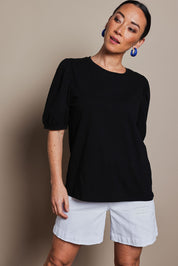 Model Katie wearing size 10 of the Cotton Jersey Puff Sleeve Top in colour Black (Black), from the front, cropped image
