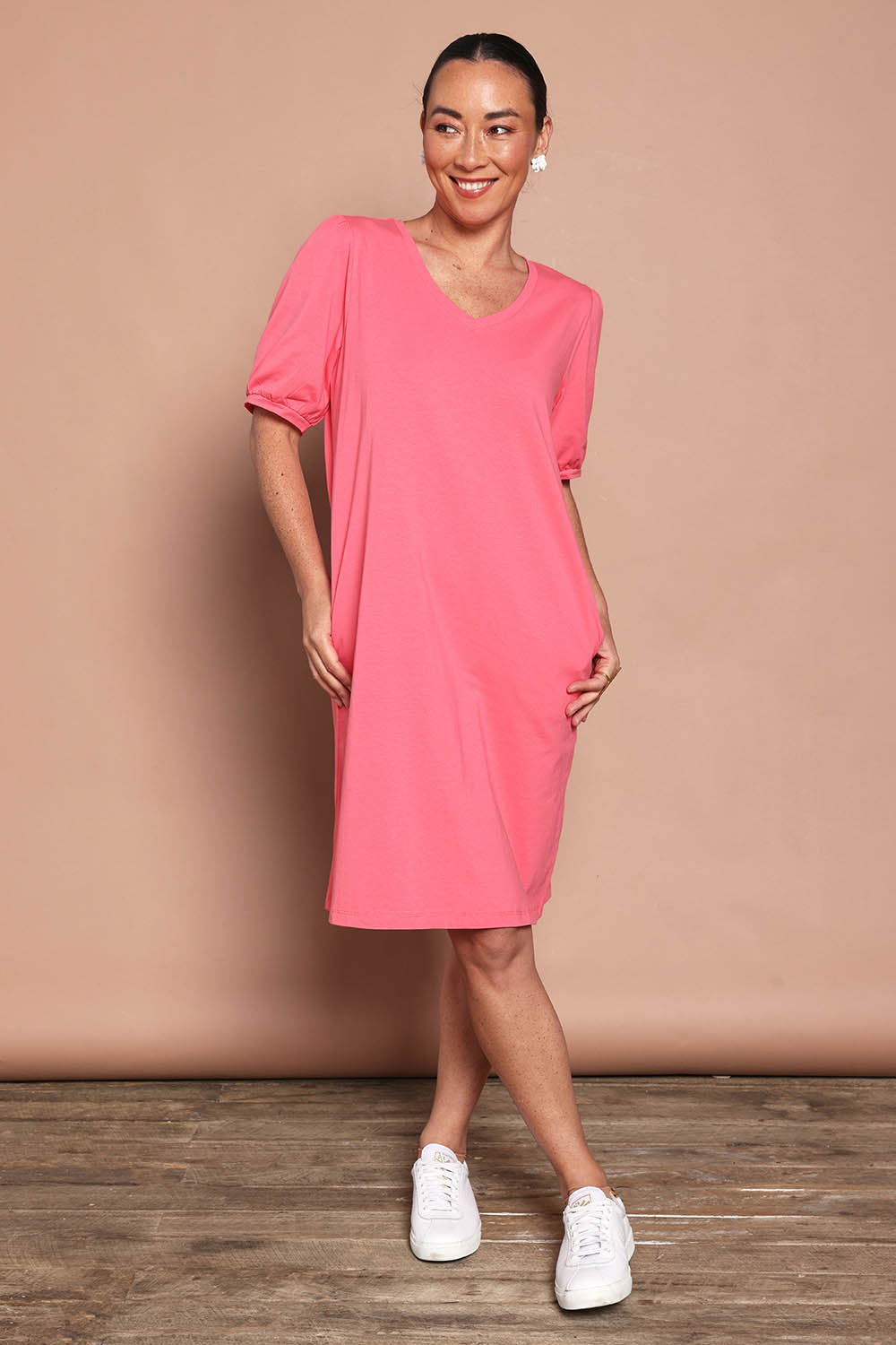 Model Katie wearing size 10 of the Cotton Jersey Puff Sleeve Dress in colour Coralpink (Pink), from the front, showing the whole outfit