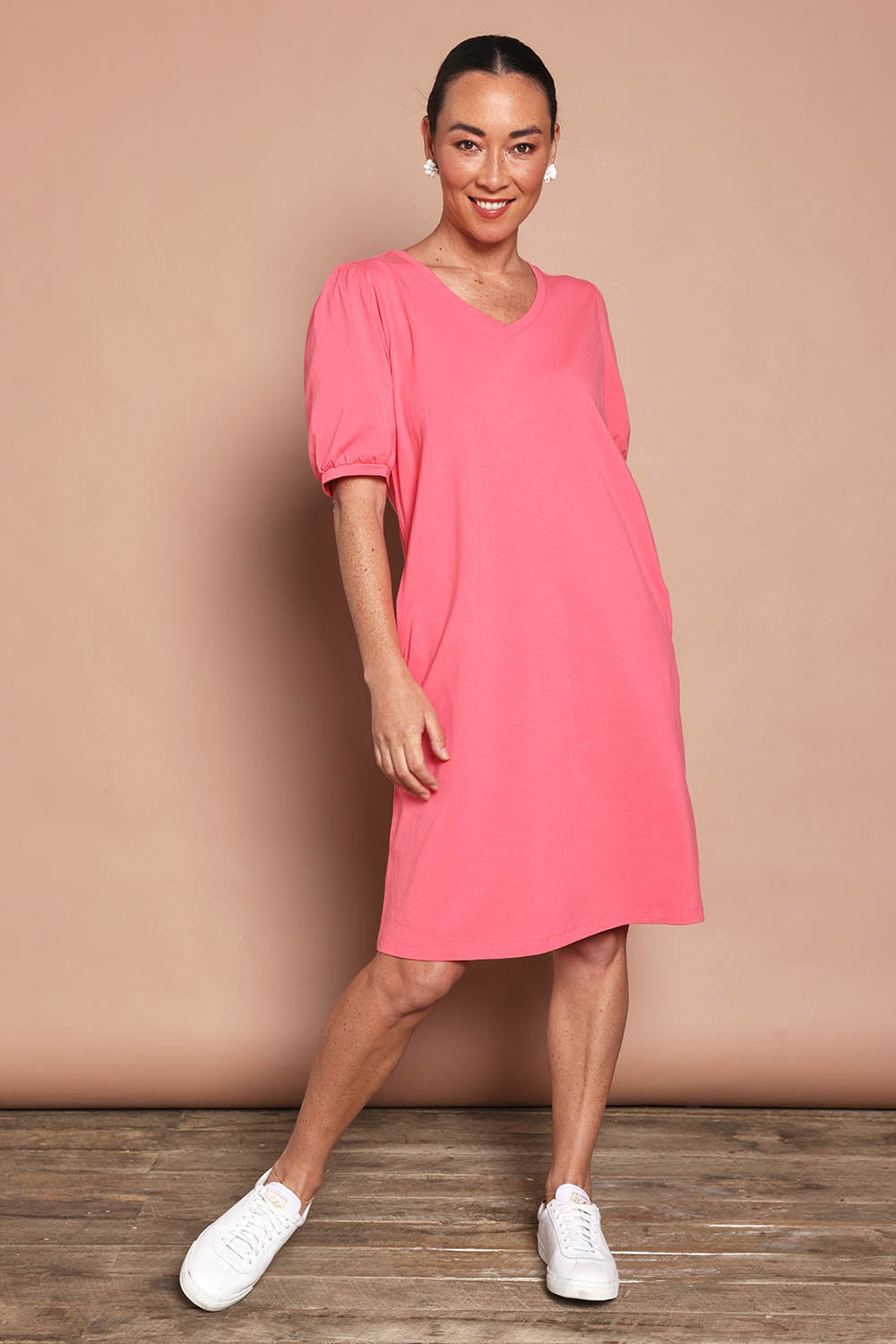 Model Katie wearing size 10 of the Cotton Jersey Puff Sleeve Dress in colour Coralpink (Pink), from the front, showing the whole outfit