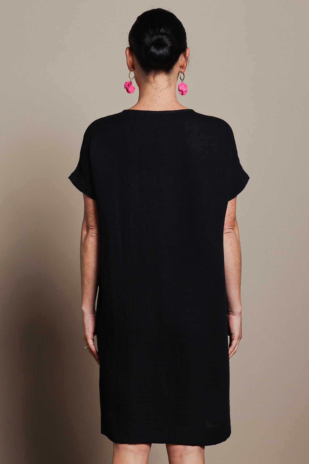 Model Katie wearing size 10 of the Viscose Linen Short Sleeve Dress in colour Black (Black), from the back
