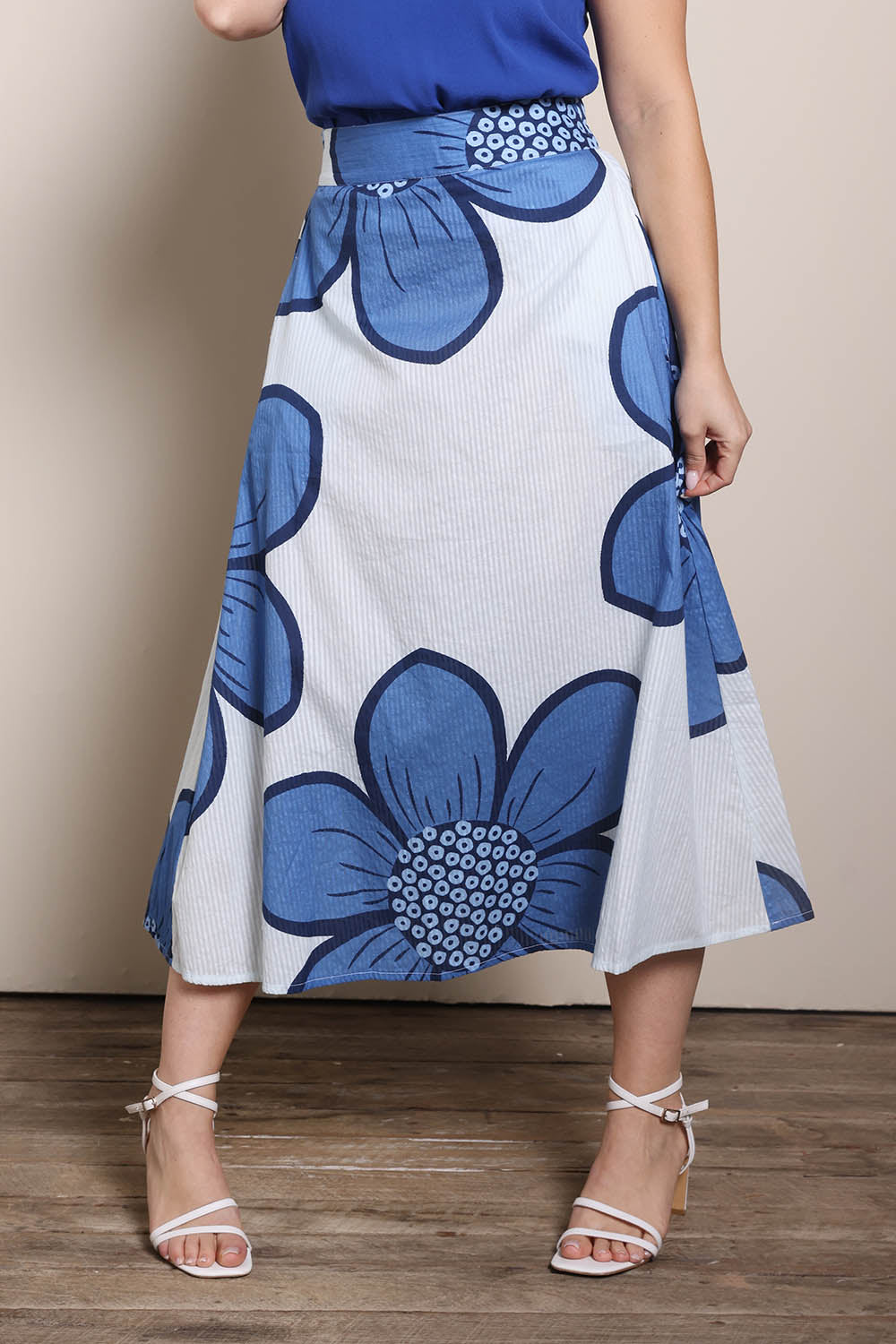 Model Georgiel wearing size 10 of the Cotton Flower Skirt – Blue in colour Blue, from the front