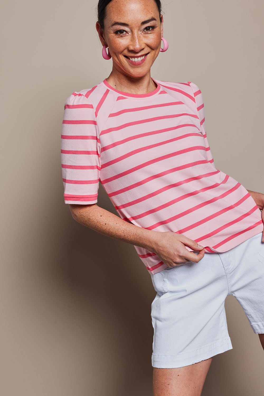 Model Katie wearing size 10 of the Cotton Stripe Puff Sleeve Top in colour Pink (Pink), from the front, cropped image