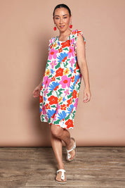 Model Katie wearing size 10 of the Printed Sleeveless Dress in colour Bloompop, from the front, showing the whole outfit
