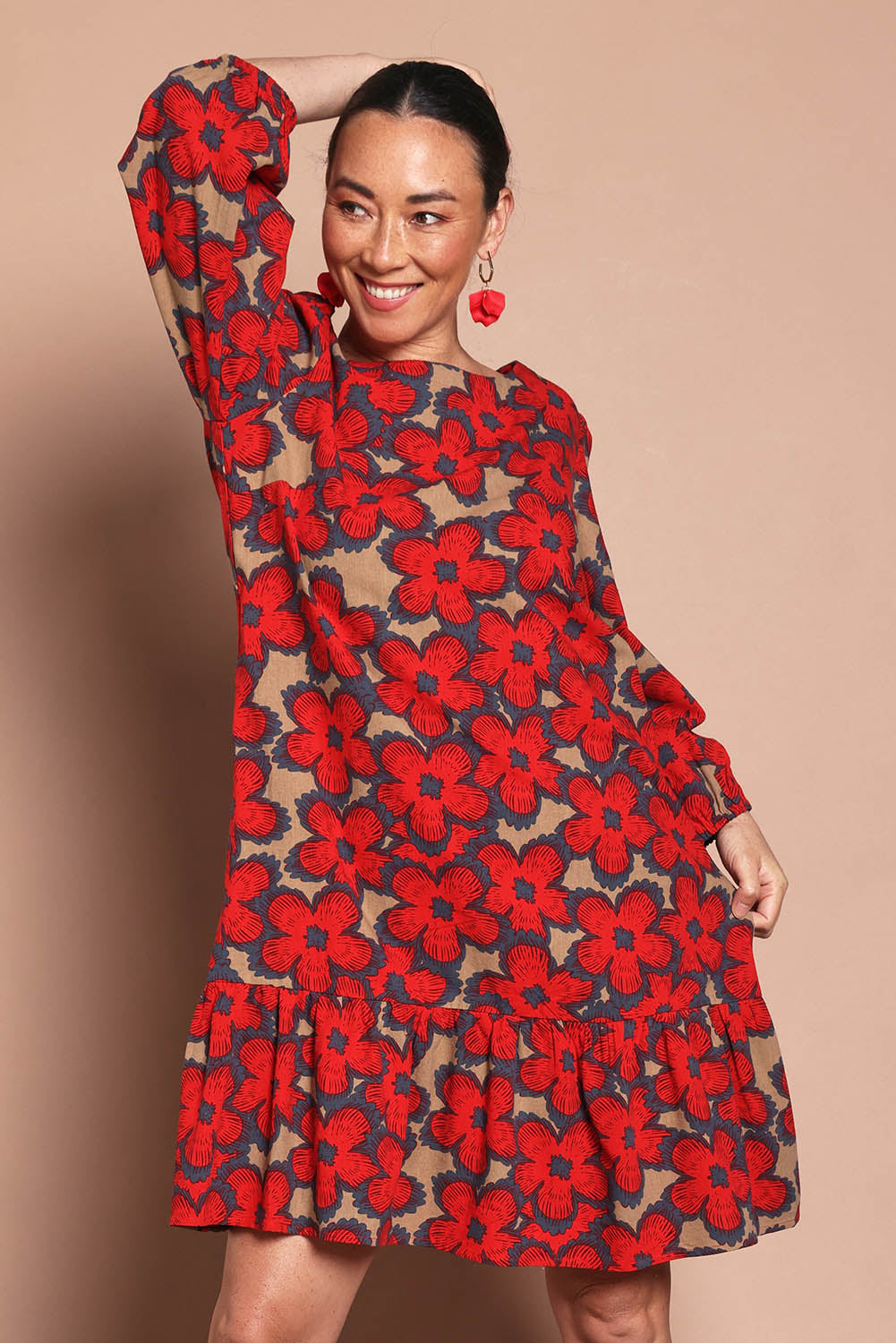 Model Katie wearing size 10 of the Cotton Frill Hem Dress in colour Poppy (Red), from the front, cropped image