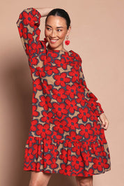 Model Katie wearing size 10 of the Cotton Frill Hem Dress in colour Poppy (Red), from the front, cropped image
